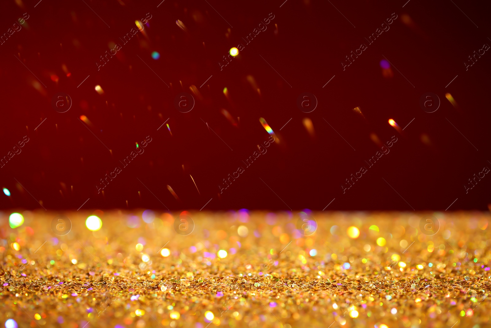 Photo of Many golden paillettes against color background. Space for text