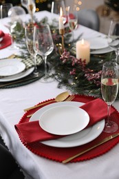 Christmas table setting with festive decor and dishware indoors