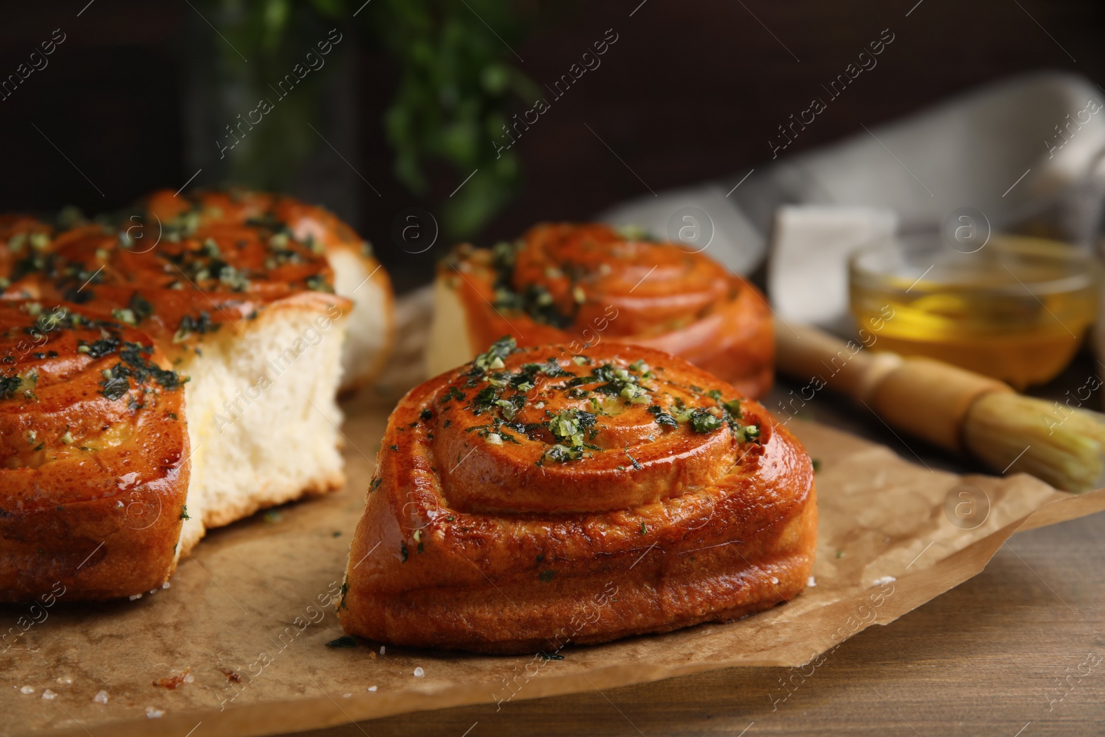 Photo of Traditional Ukrainian bread (Pampushky) with garlic on wooden table