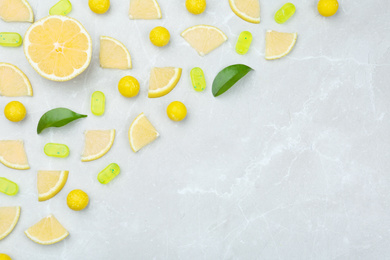 Photo of Flat lay composition with lemon drops on grey marble table. Space for text