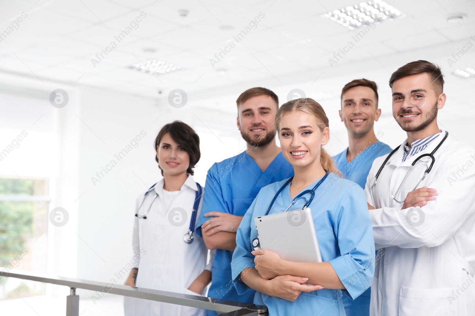 Photo of Team of doctors with tablet at workplace