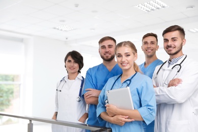 Photo of Team of doctors with tablet at workplace