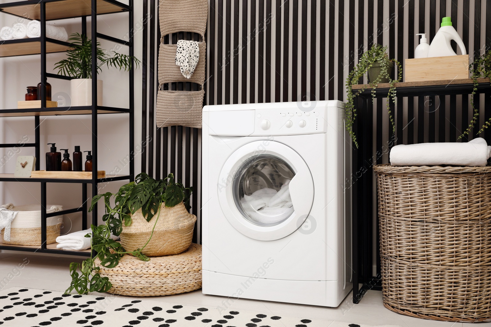 Photo of Laundry room interior with washing machine and stylish furniture