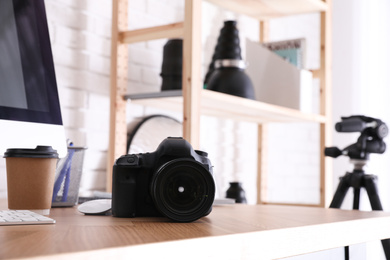 Photographer's workplace with professional camera in office