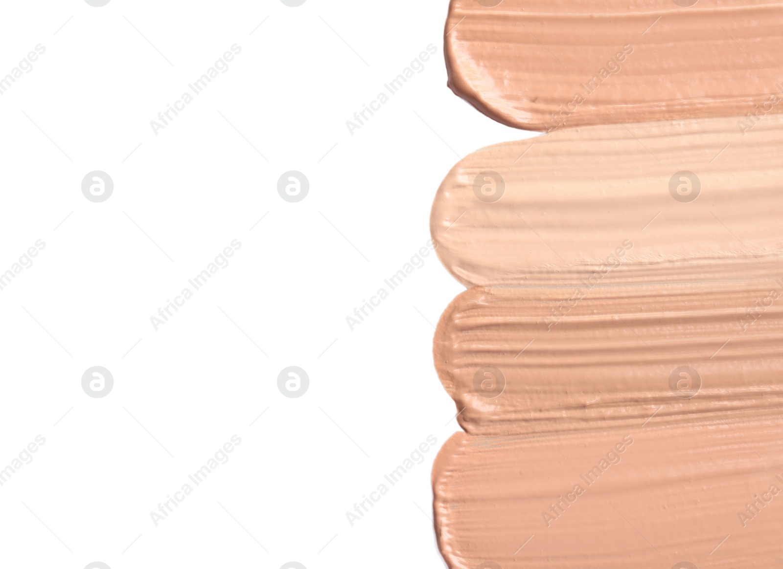 Photo of Samples of different foundation shades on white background, top view