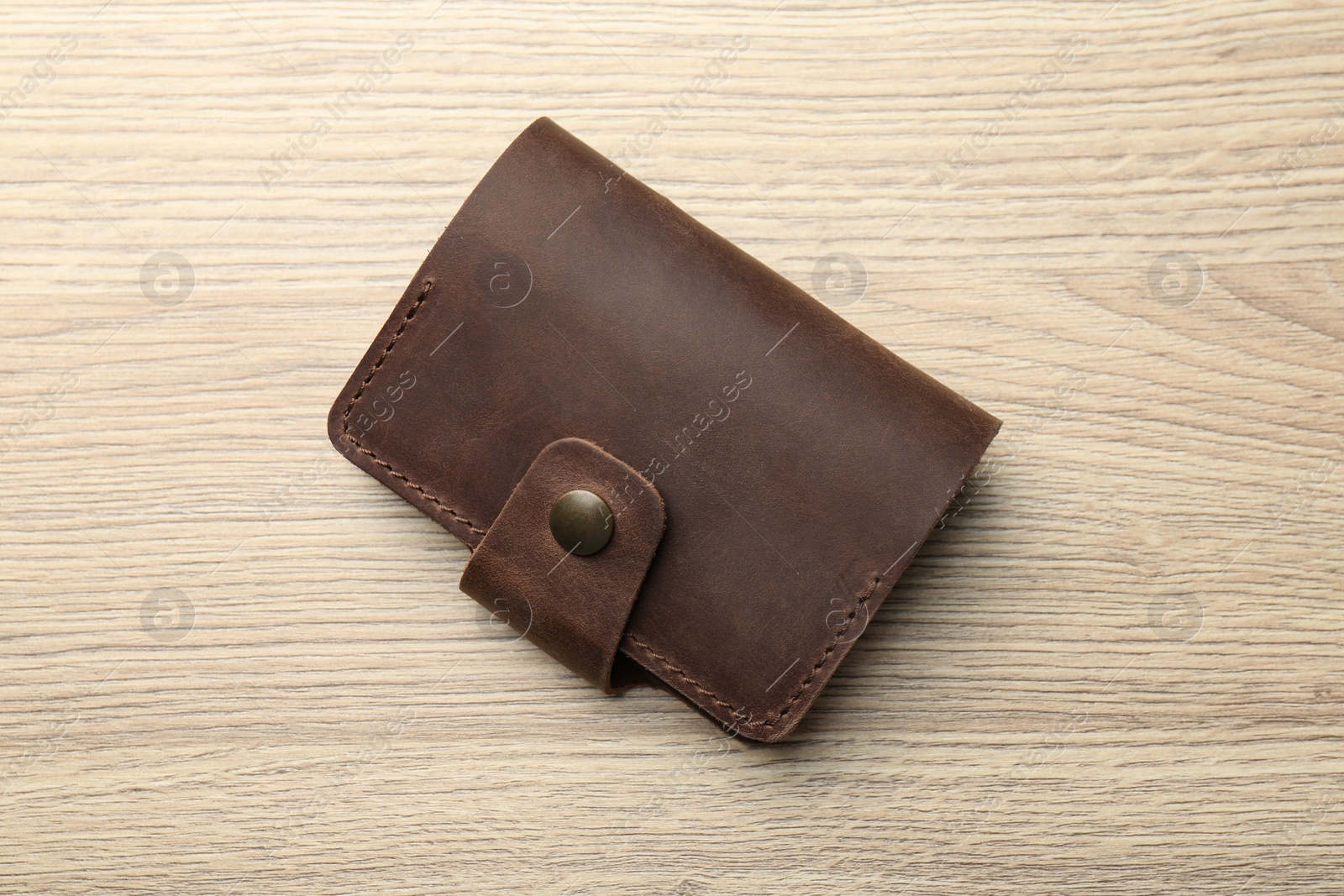 Photo of Leather business card holder on wooden table, top view