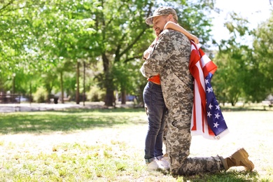 Photo of American soldier with his son outdoors. Military service