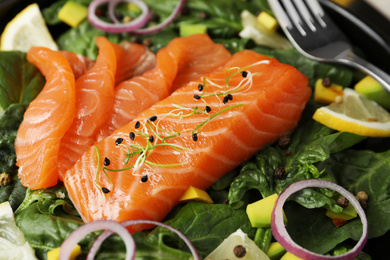 Photo of Delicious fresh salmon with spinach on plate, closeup