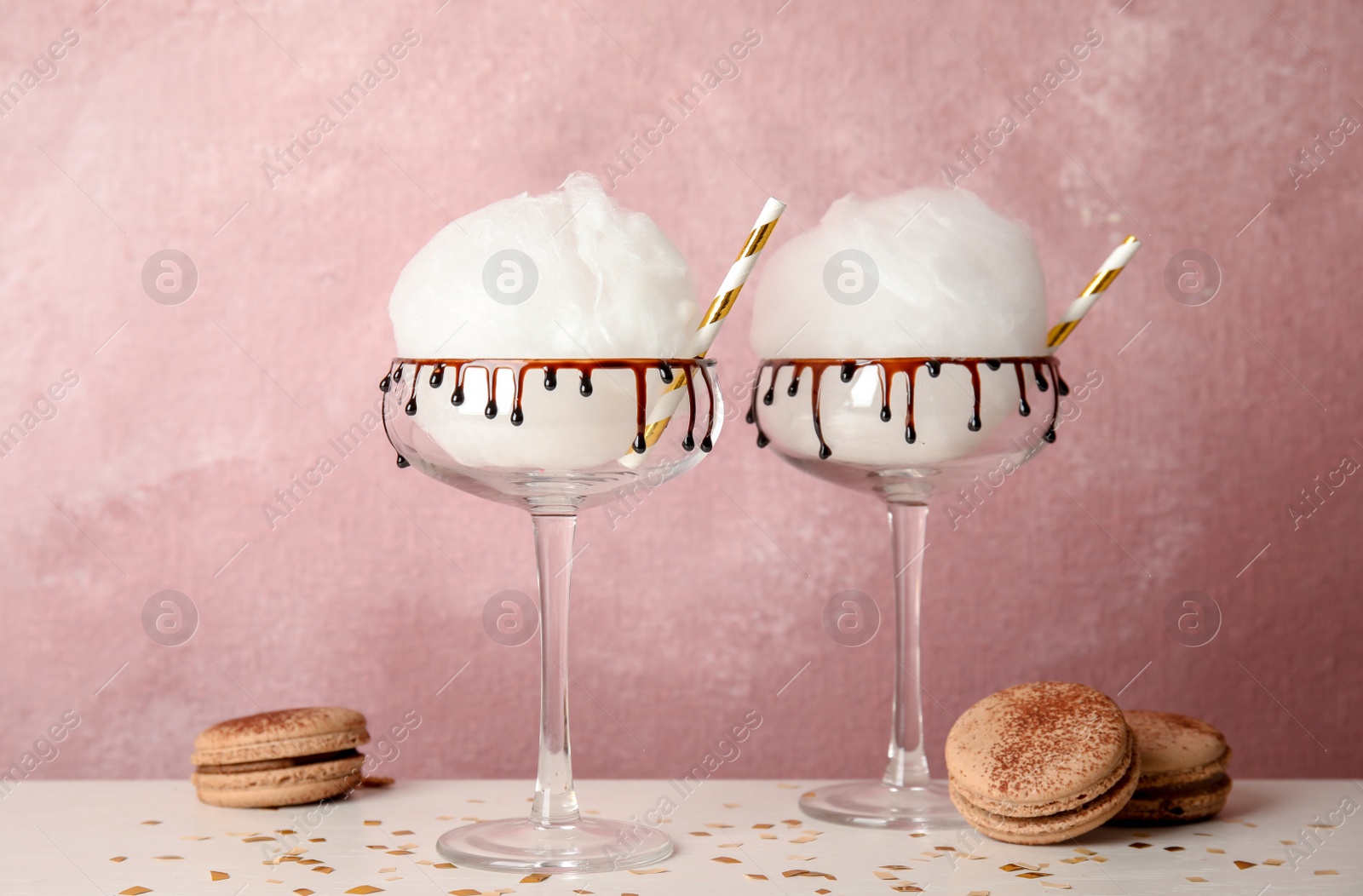 Photo of Cotton candy served in cocktail glasses on table