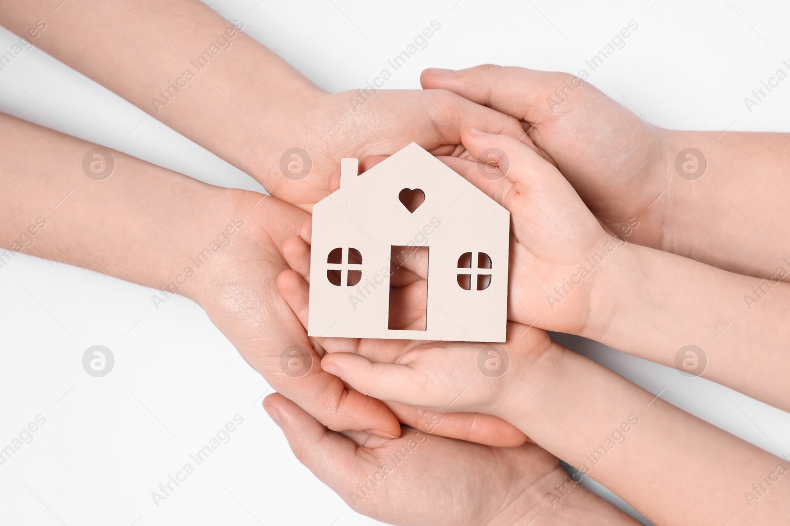 Photo of Home security concept. Family holding house model on white background, top view