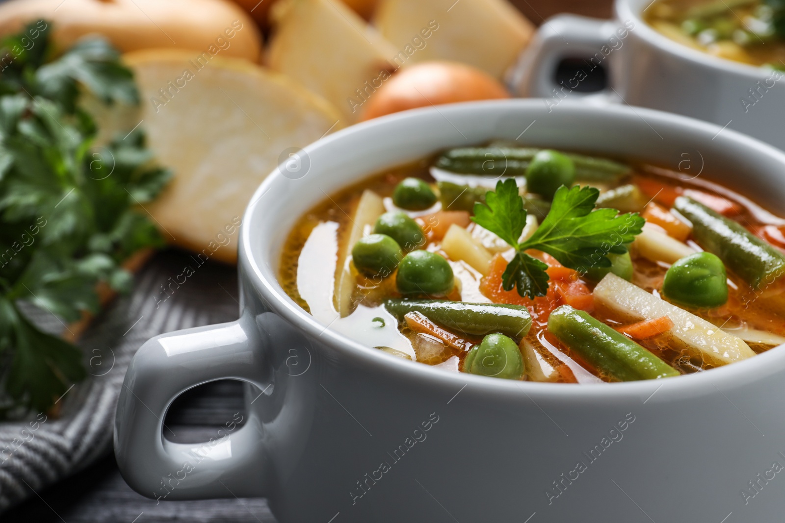 Photo of Bowl of tasty turnip soup on table, closeup