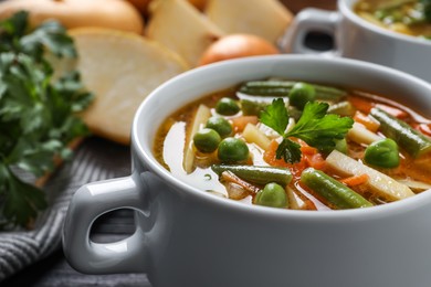 Photo of Bowl of tasty turnip soup on table, closeup