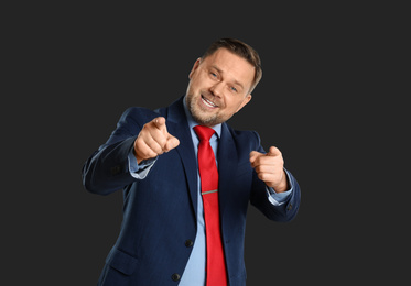 Photo of Portrait of happy mature man on black background