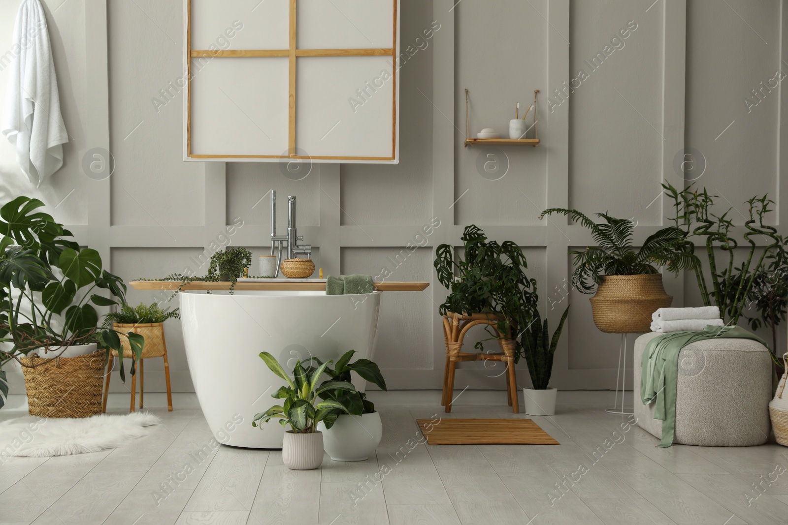 Photo of Stylish bathroom interior with green plants. Home design