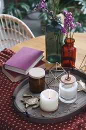 Photo of Wooden tray with decorations and books on table indoors