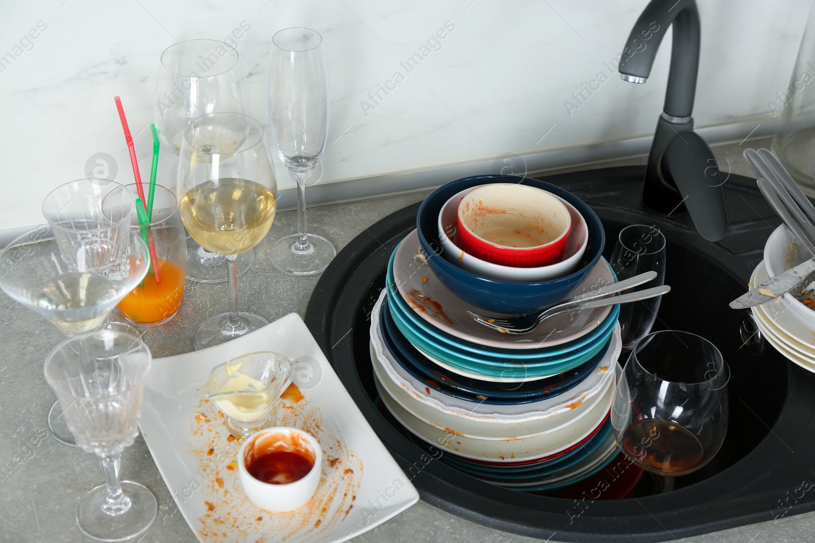 Photo of Pile of dirty dishes in kitchen after party