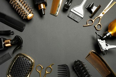 Photo of Frame of hairdressing tools on dark background, flat lay. Space for text