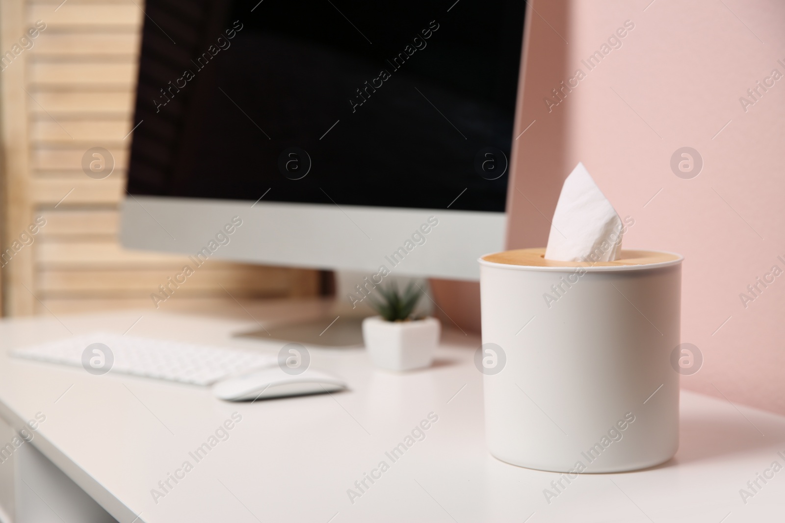 Photo of Box with paper tissues on white table at workplace