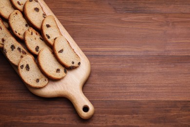 Sweet hard chuck crackers with raisins on wooden table, top view. Space for text