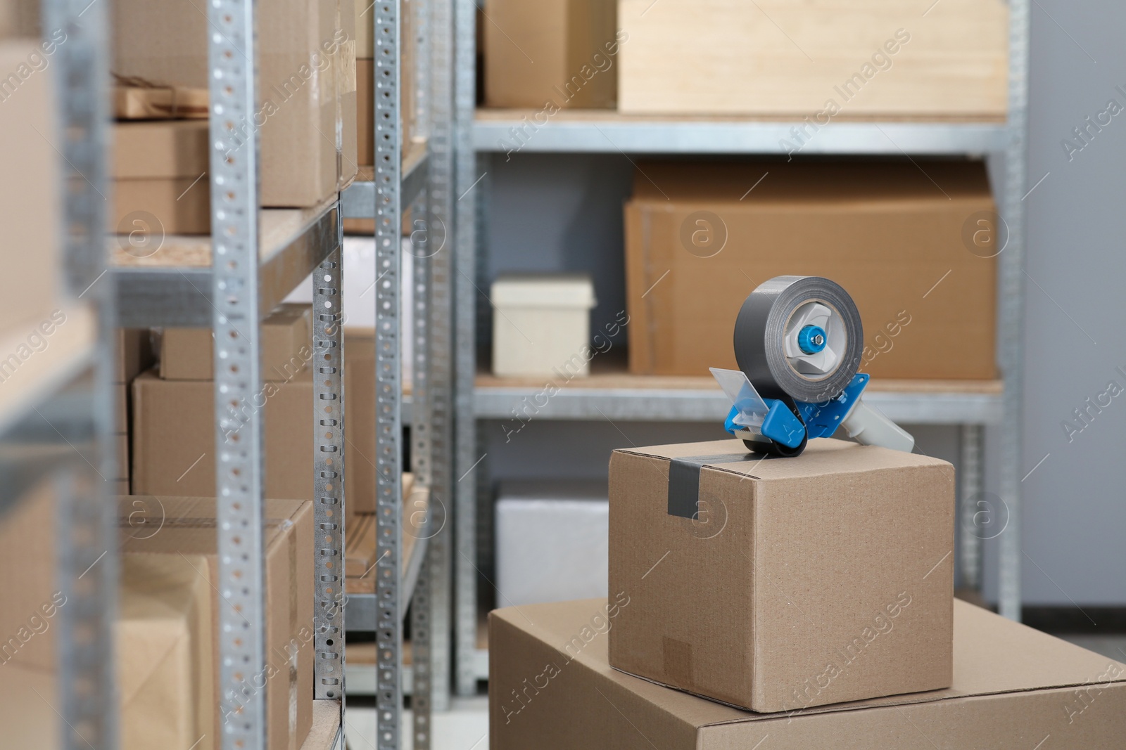 Photo of Taping box with adhesive tape dispenser indoors. Space for text