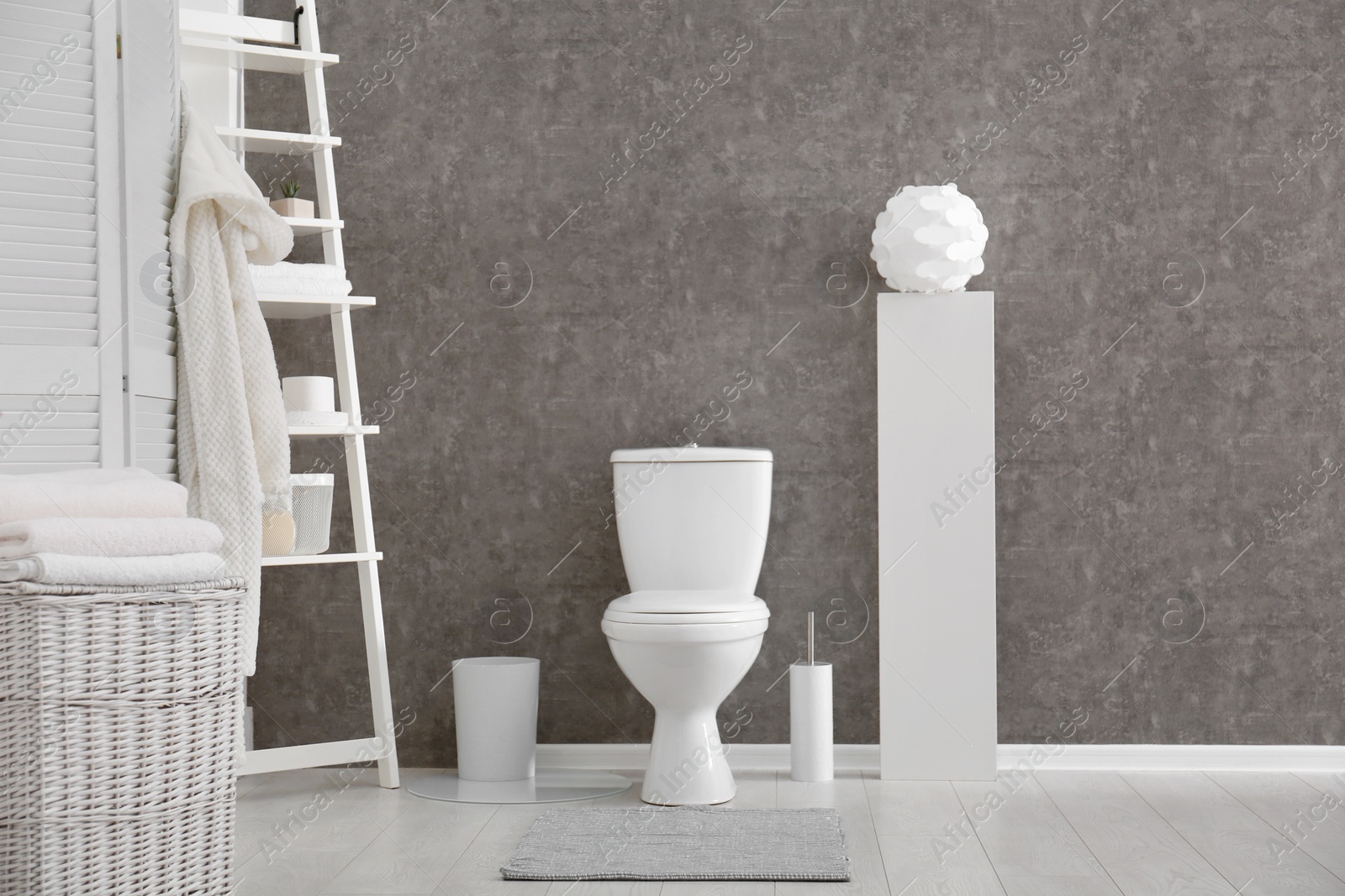 Photo of Ceramic toilet bowl in stylish bathroom. Idea for interior design