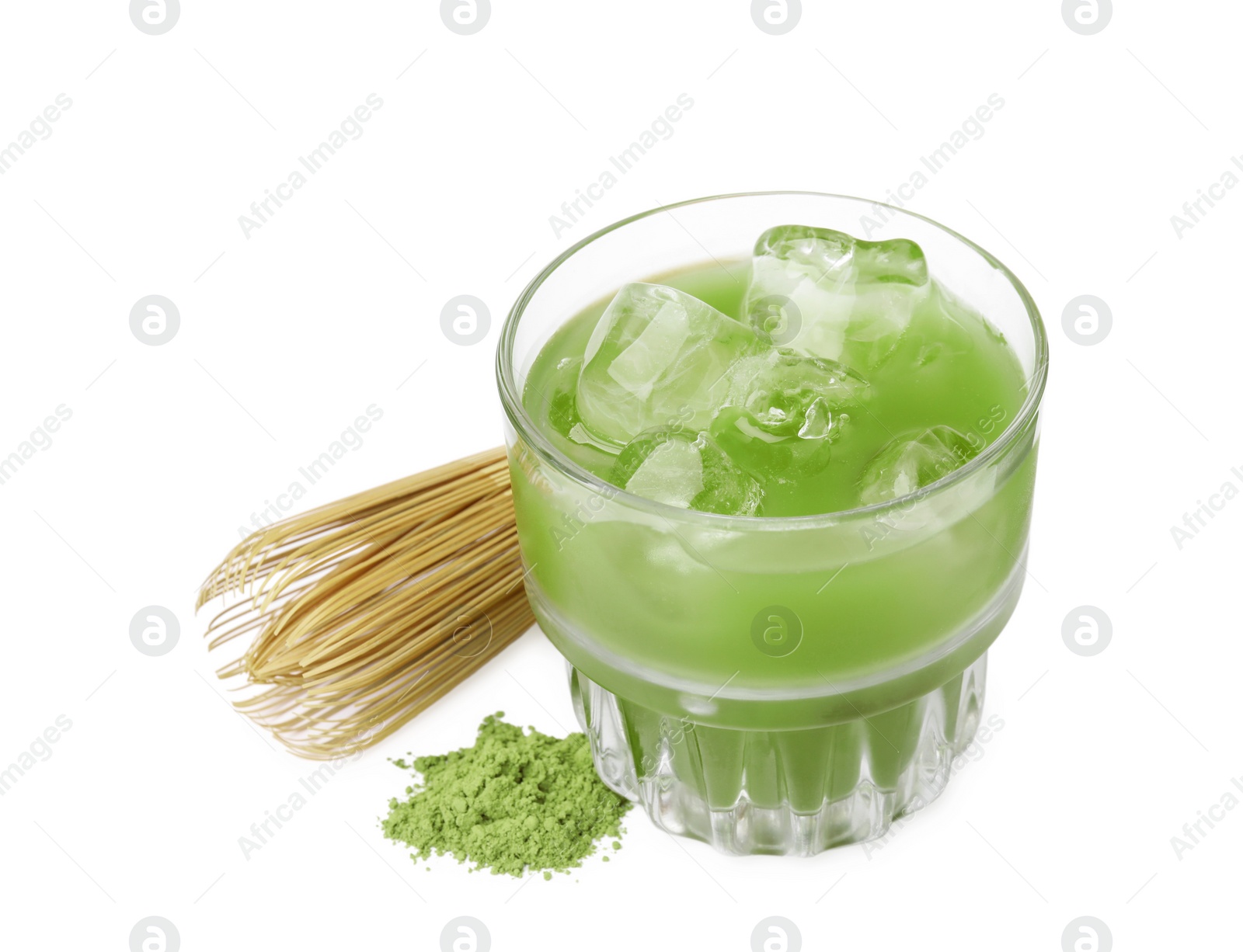 Photo of Glass of delicious iced green matcha tea, powder and bamboo whisk isolated on white