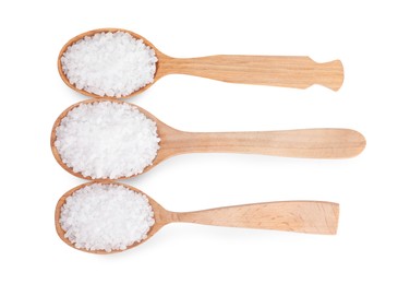 Photo of Wooden spoons with natural sea salt isolated on white, top view