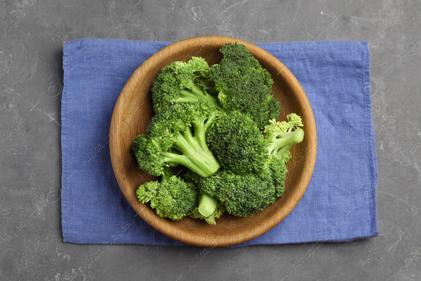 Photo of Fresh green broccoli on grey table, top view