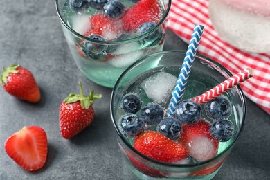 Glasses of natural lemonade with berries on table