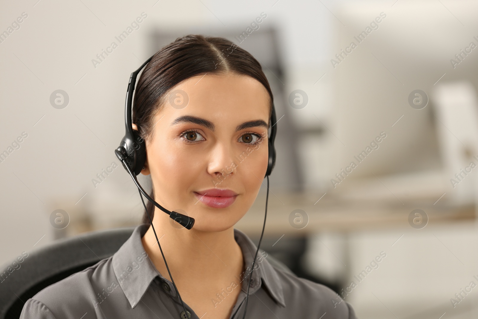 Photo of Hotline operator with headset working in office