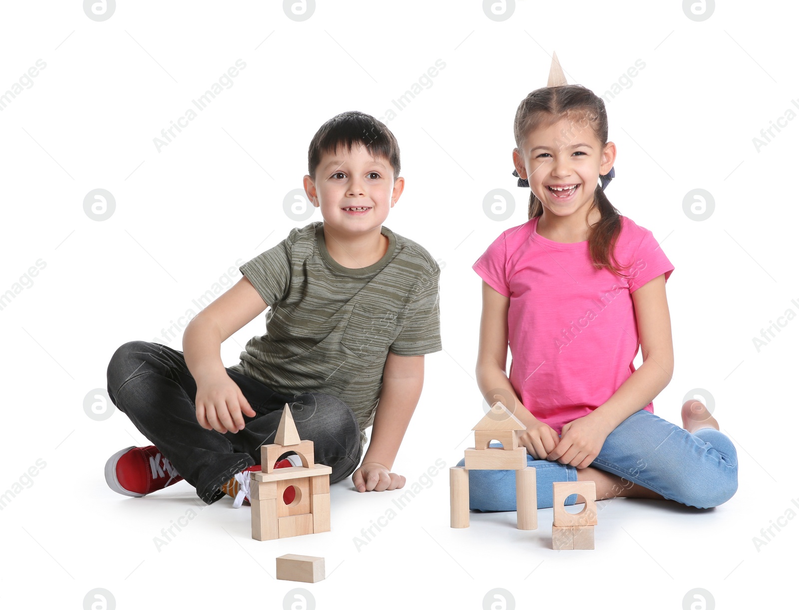 Photo of Cute children playing with wooden blocks on white background