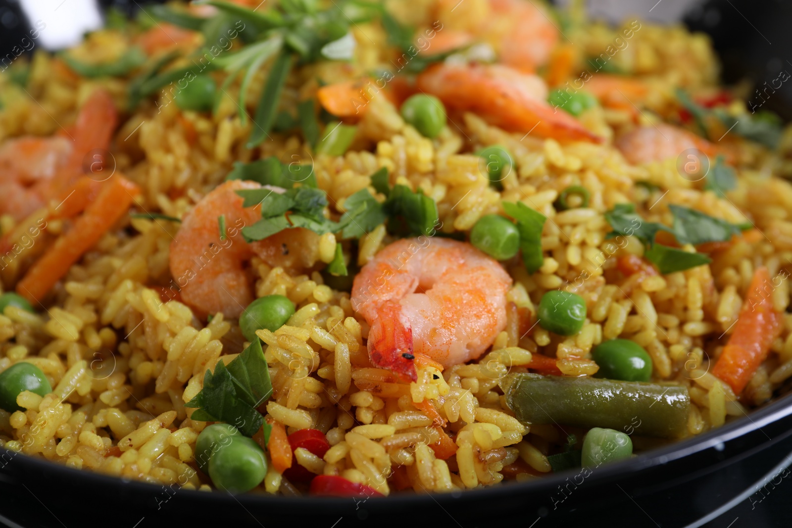 Photo of Tasty rice with shrimps and vegetables, closeup
