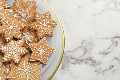 Photo of Tasty Christmas cookies on white marble table, top view. Space for text