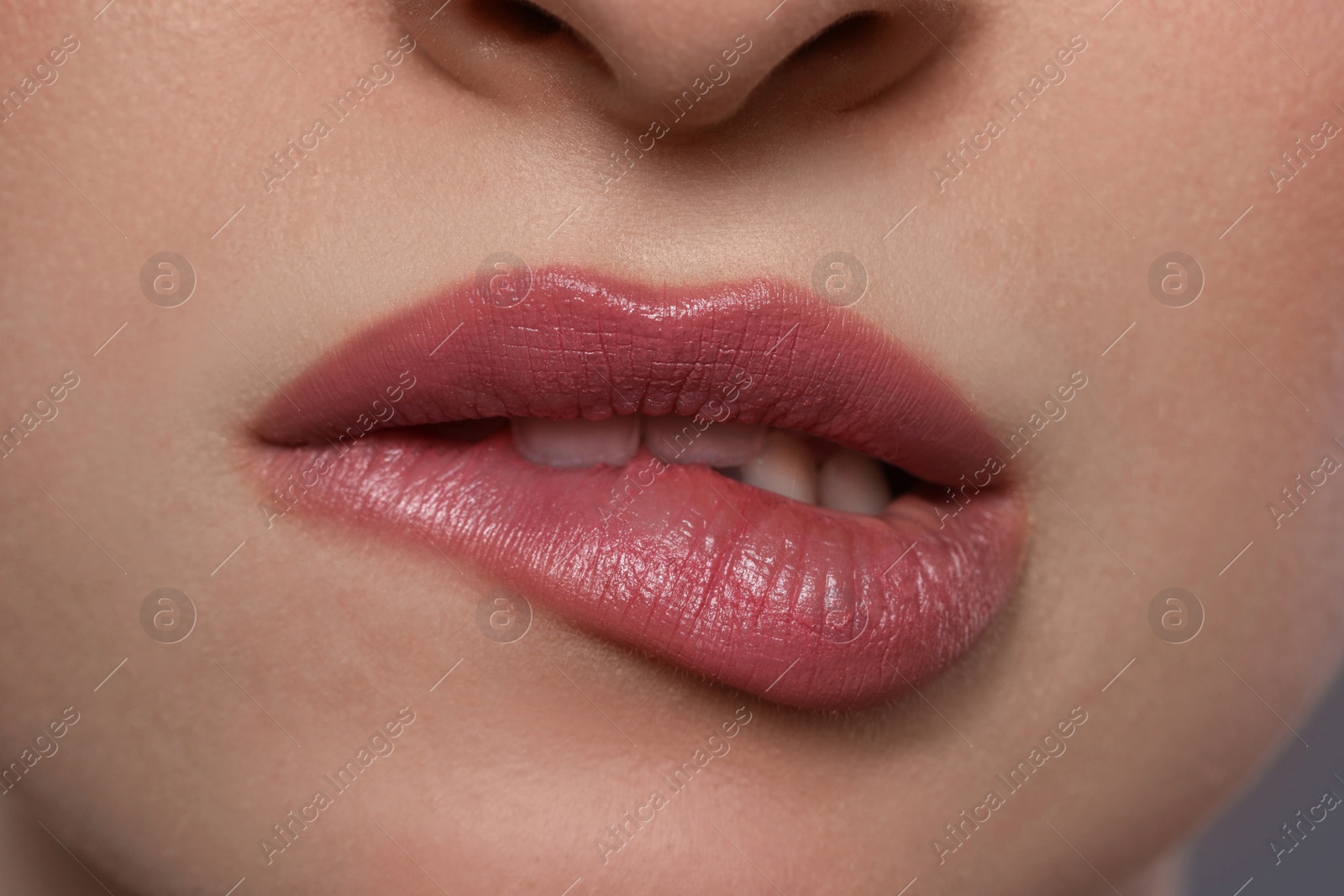 Photo of Young woman with beautiful plump lips, closeup