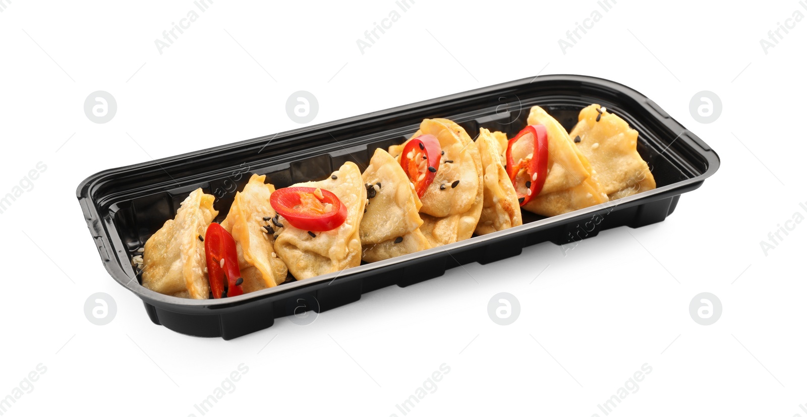 Photo of Delicious gyoza (asian dumplings) with sesame and pepper isolated on white