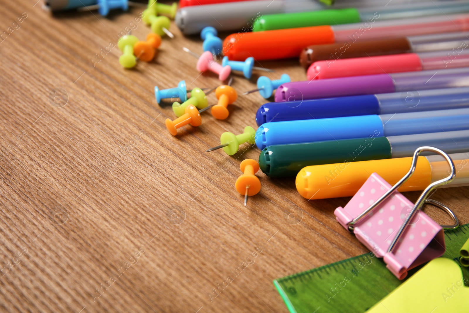 Photo of Different stationery on wooden table. Back to school