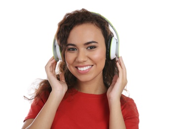 Photo of African-American girl listening to music with headphones on white background