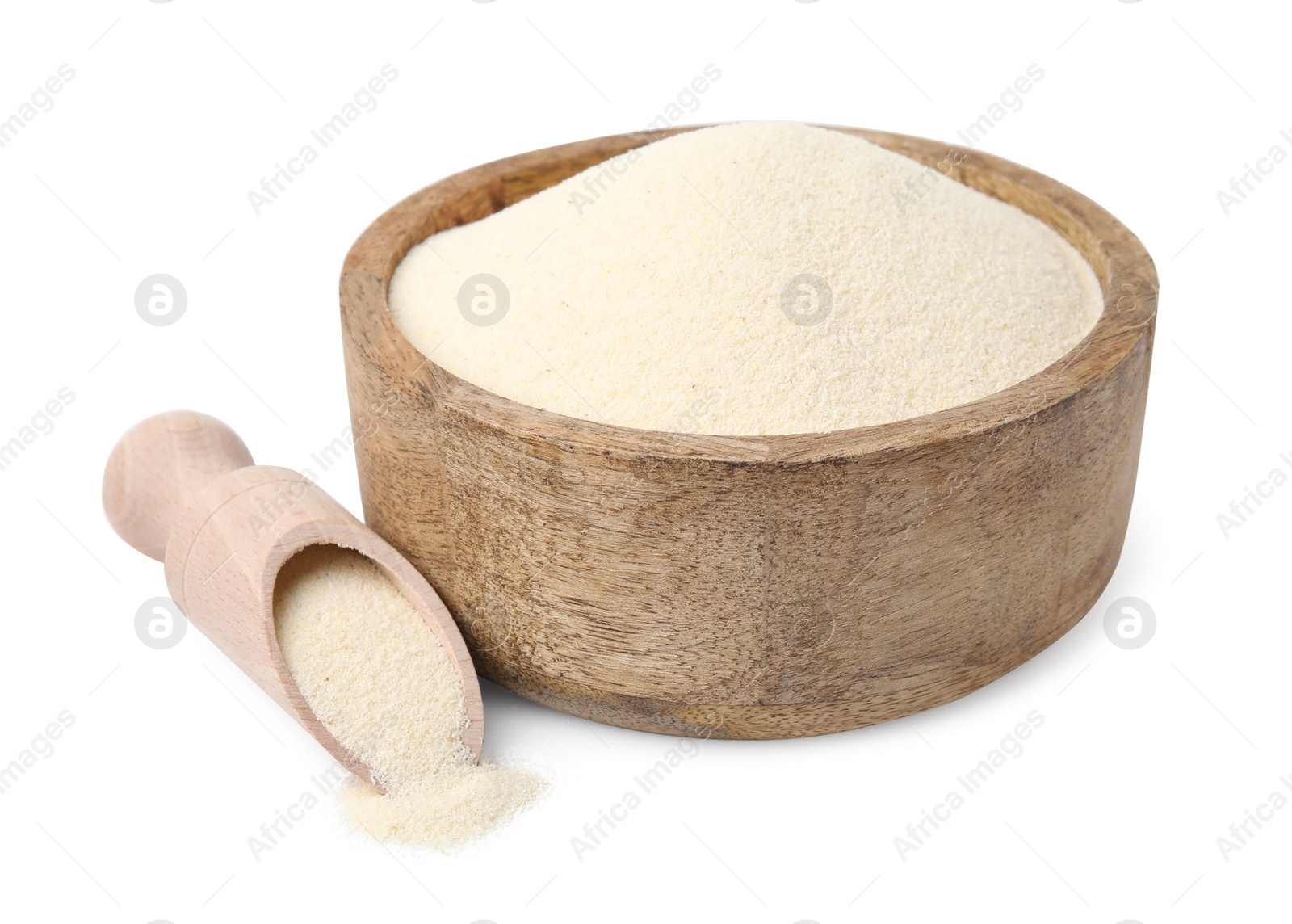 Photo of Uncooked organic semolina in wooden bowl and scoop isolated on white