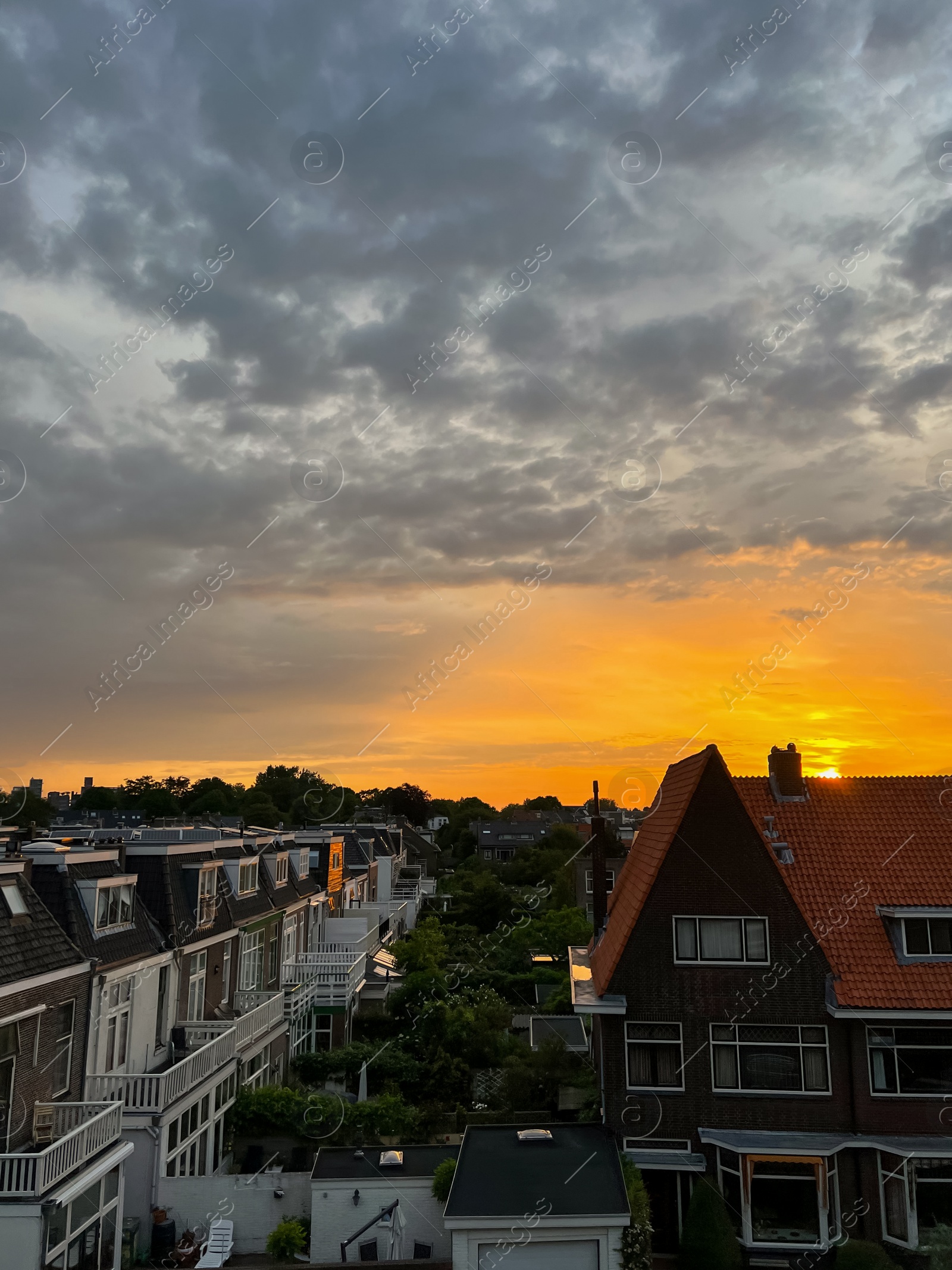 Photo of Picturesque view of city street with beautiful buildings at sunrise