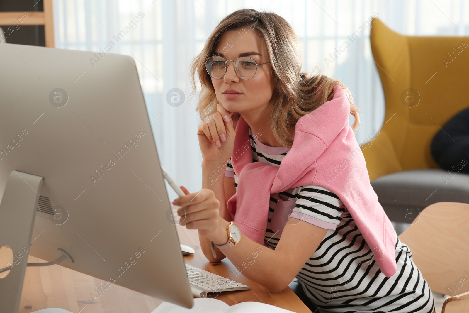 Photo of Online test. Woman studying with computer at home