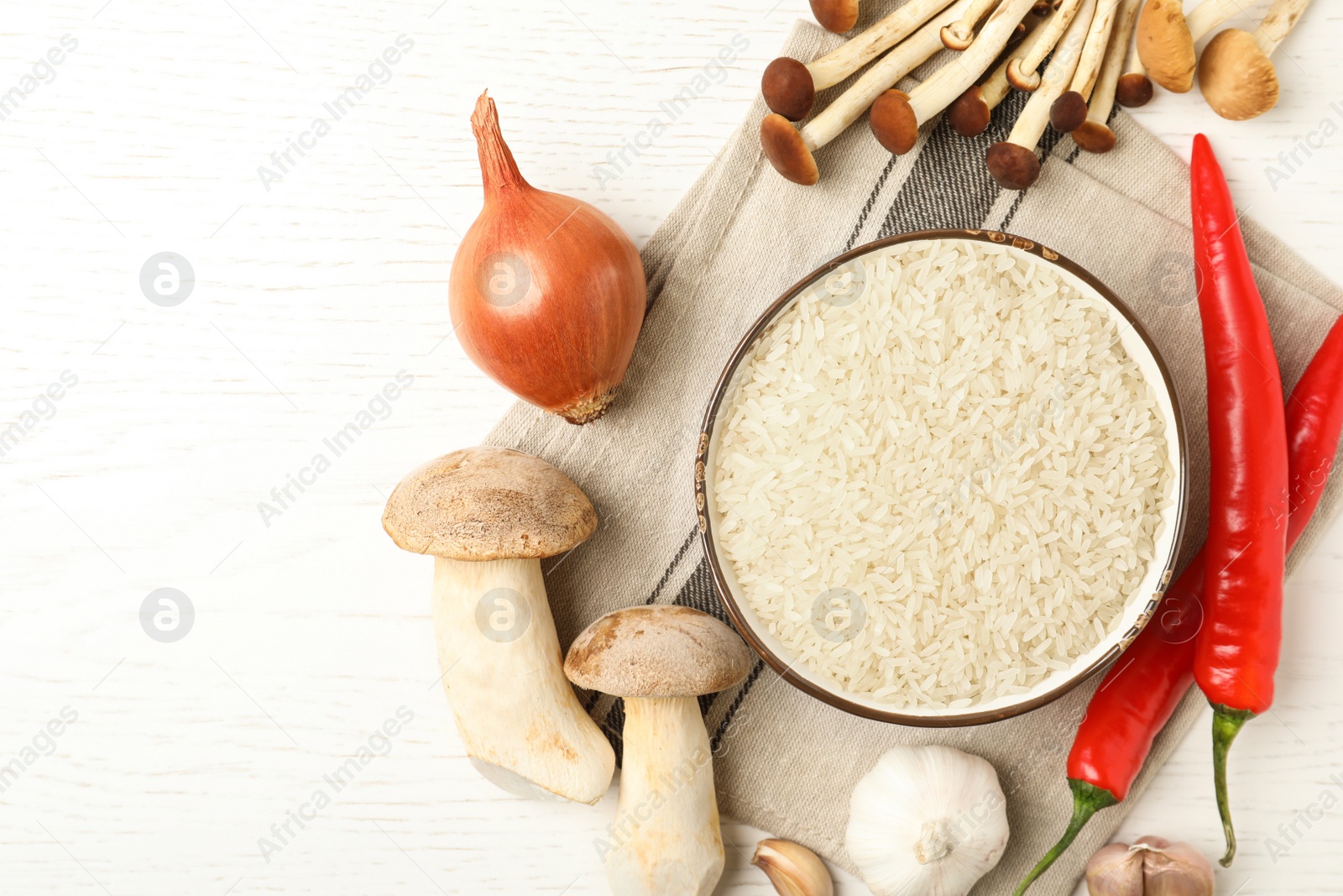 Photo of Flat lay composition with different ingredients on white wooden table. Risotto recipe