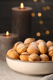 Bowl of delicious nut shaped cookies on grey table, closeup