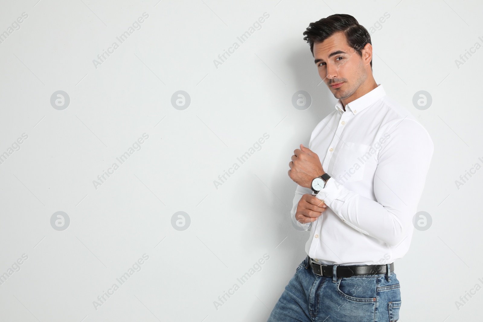 Photo of Portrait of handsome young man on light background. Space for text