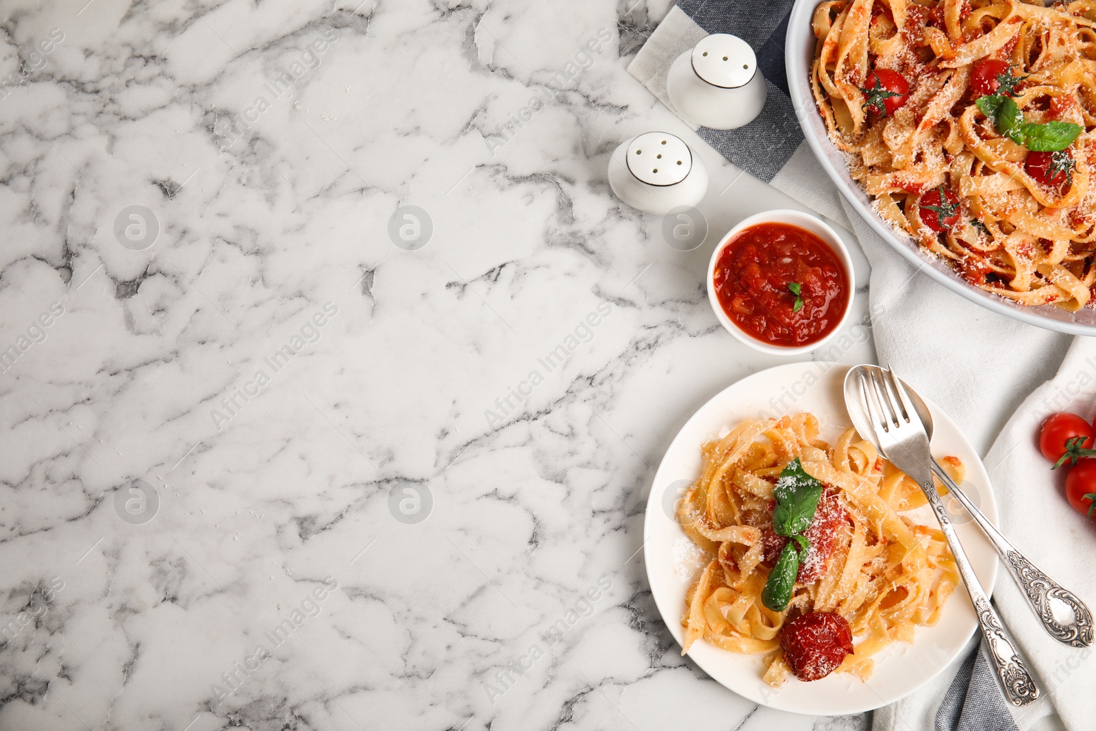 Photo of Flat lay composition with tasty pasta on white marble table, space for text