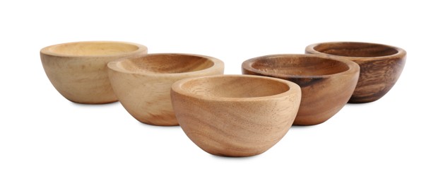 Set of wooden bowls on white background