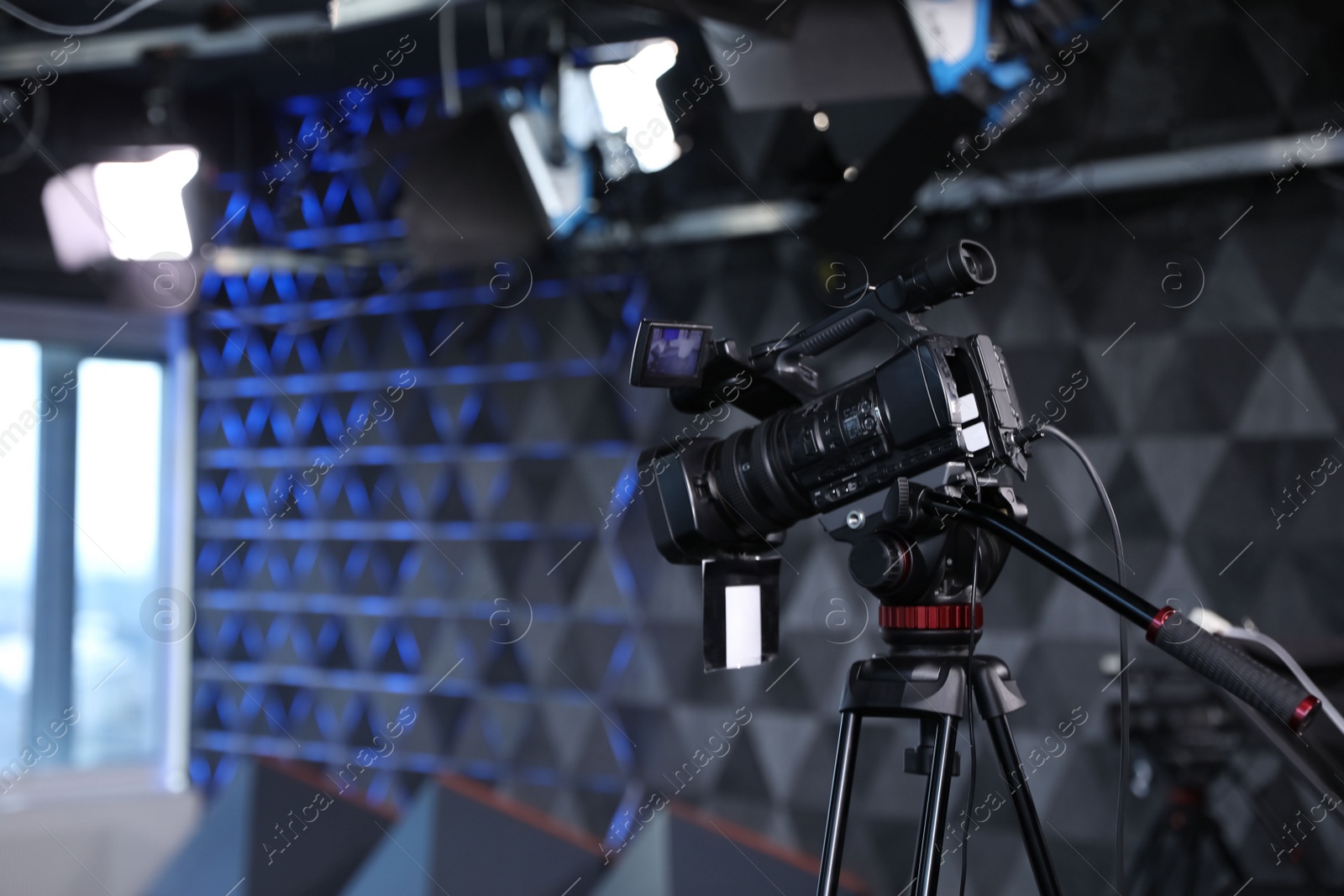 Photo of Modern video recording studio with professional equipment, focus on camera