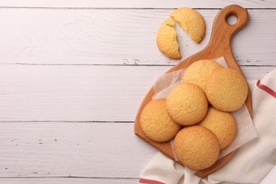 Photo of Delicious Danish butter cookies on white wooden table, flat lay. Space for text