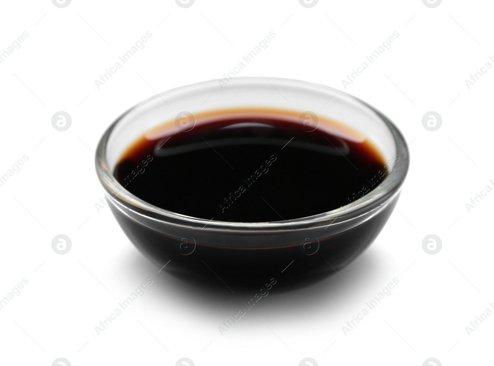 Photo of Bowl of tasty soy sauce isolated on white