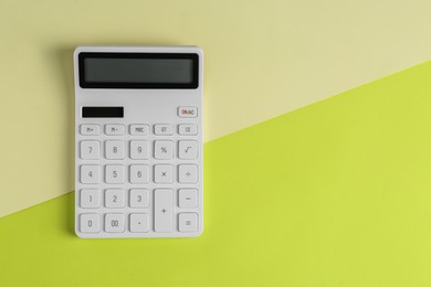 Photo of Modern calculator on color background, top view. Space for text