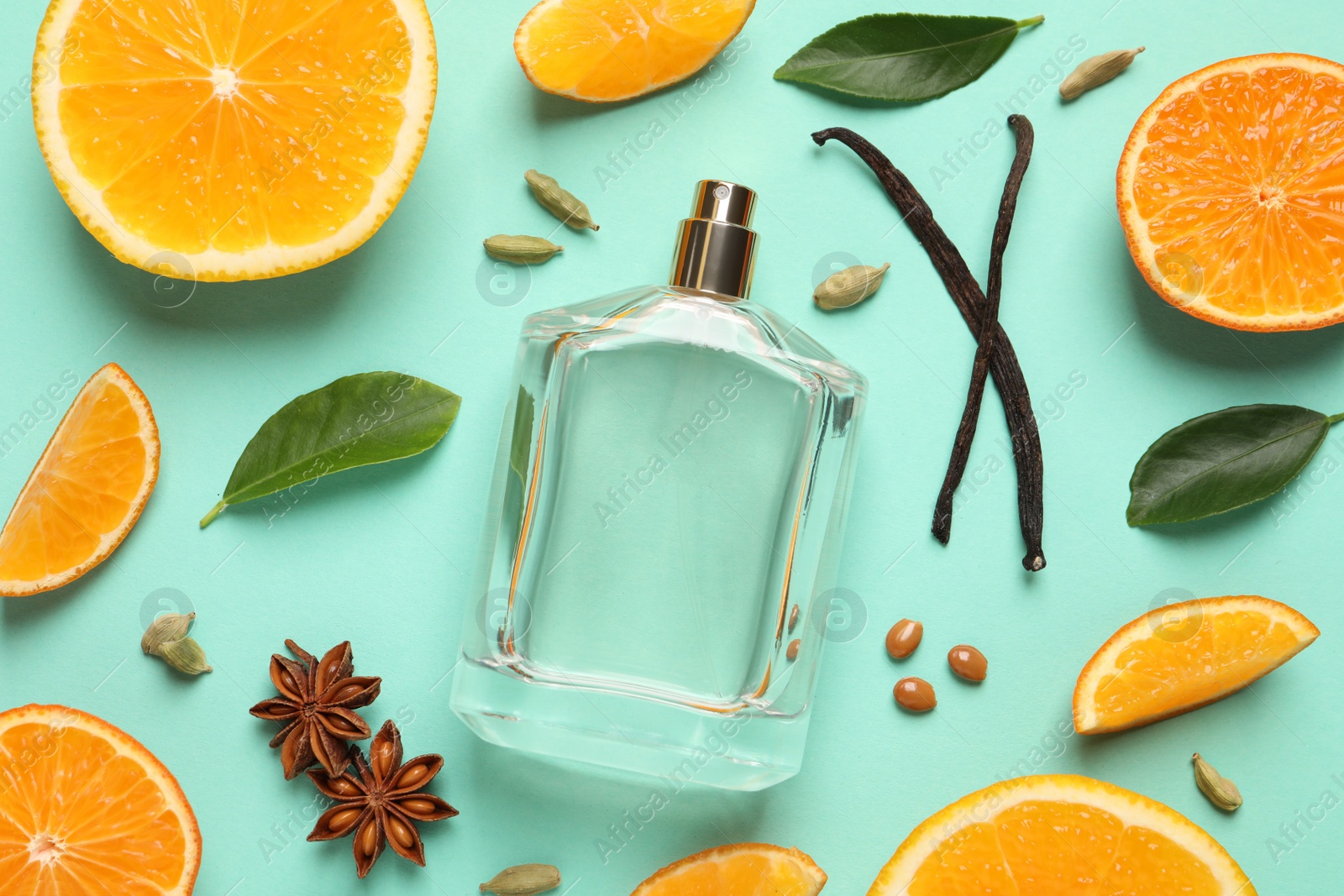 Photo of Flat lay composition with bottle of perfume and fresh citrus fruits on turquoise background
